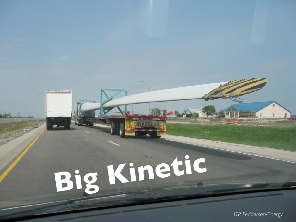 A large turbine blade transported via truck.