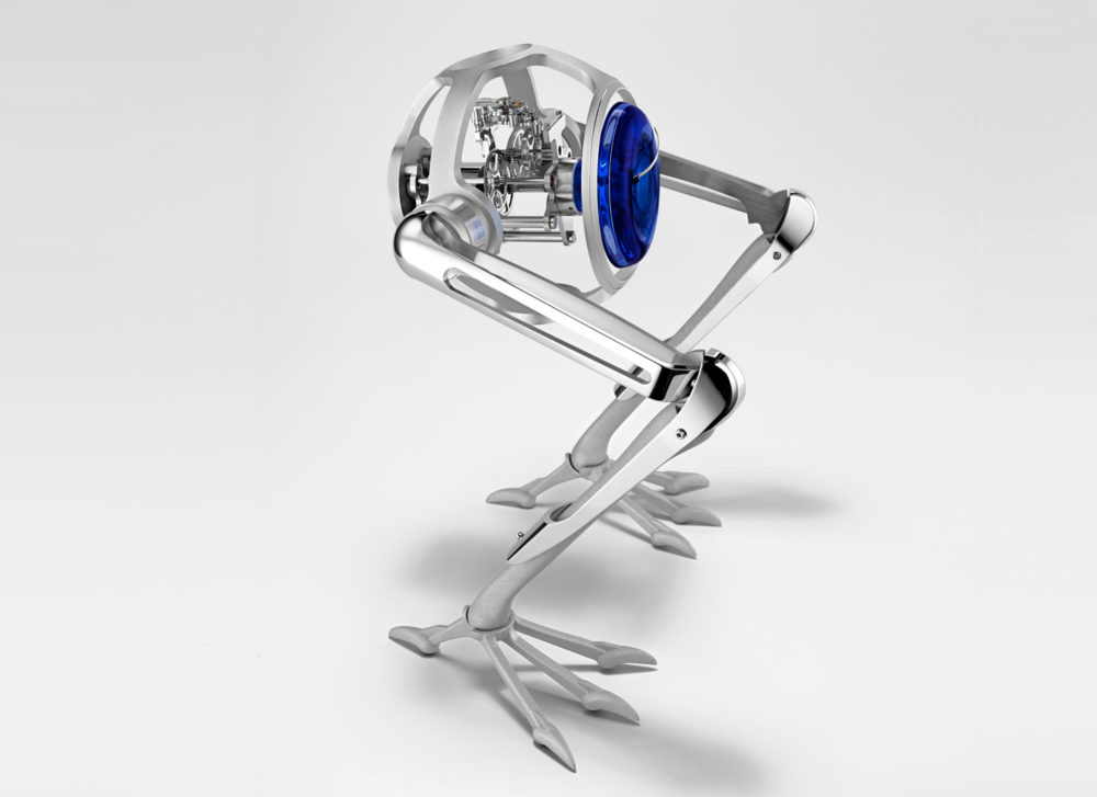 A chrome sphere with internal clockwork supported on two anatomical metal legs. 