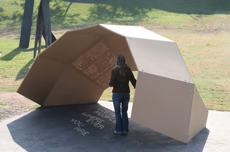 A perforated pavilion uses the moving sun to cast a changing poem in it's shadow.