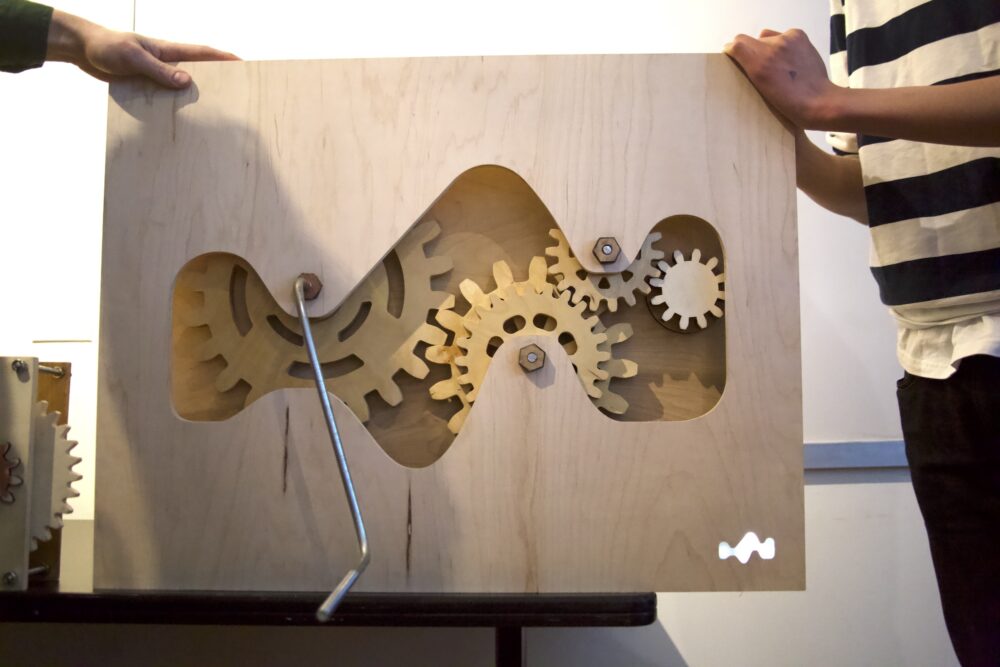 A hand-cranked light with large wooden gears